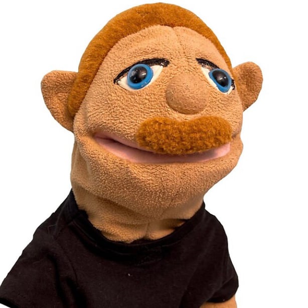 A puppet character with a cheerful expression ready to sing the baby back ribs jingle